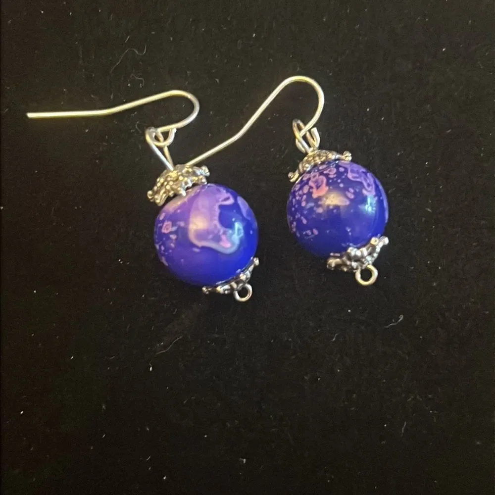 Handcrafted purple and silver tone earrings.